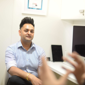 Amish Patel, Award-Winning Aesthetics Practitioner In Consultation With Client On Face Fillers