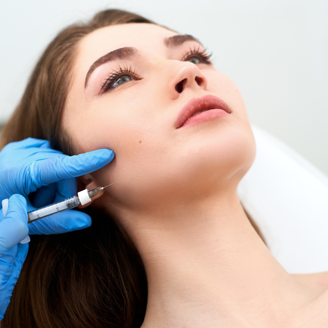 Woman having dermal filler injections to get rid of jowls and create a more snatched jawline.