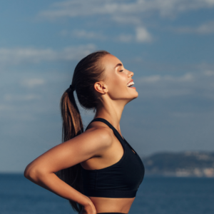 Woman feeling elated after exercise which can give you more youthful glowing skin and boost your confidence