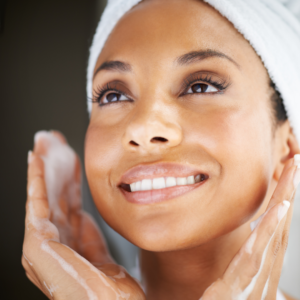 woman exfoliating her face to reveal younger looking skin