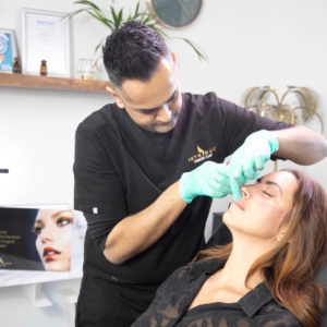 Amish Patel award-winning aesthetics practitioner treating a client for lip filler at his flagship clinic in Gravesend Kent