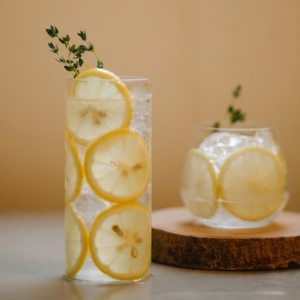 A tasty glass of water with lemon to drink following lip fillers to stay hydrated.