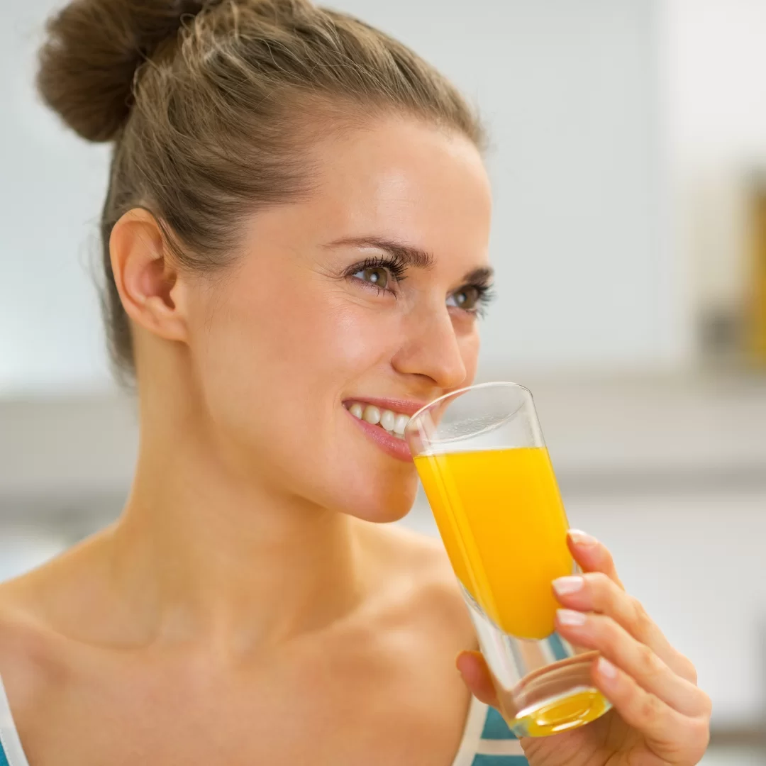 woman drinking a collagen supplement with glowing skin